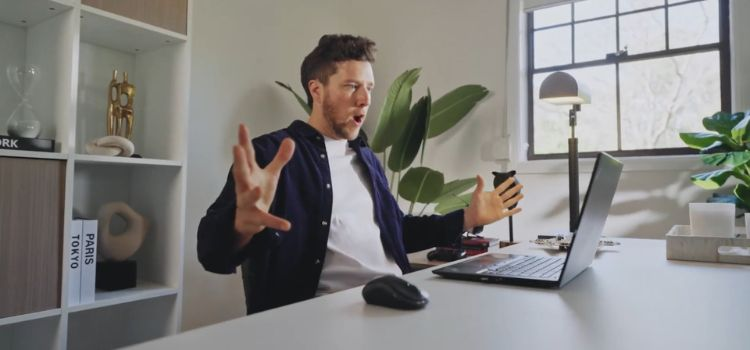 man sitting infront of a laptop