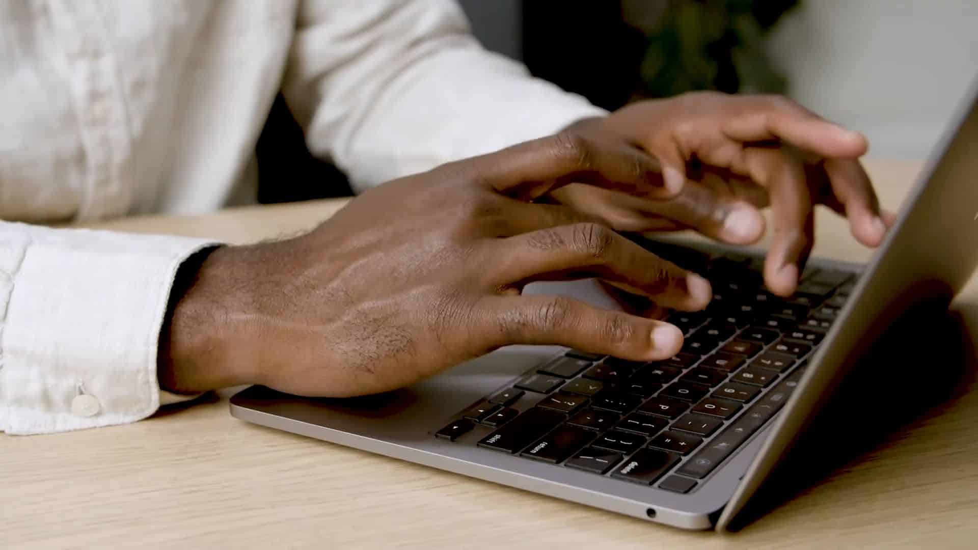 close up image of a hand typing on a laptop