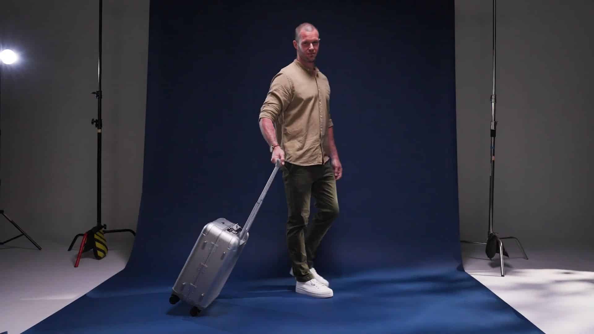 man walks in profile across a professional photo studio