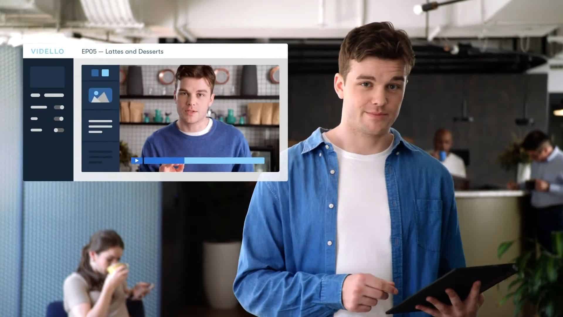 Man holding a tablet presenting an online video lesson interface in a modern office setting