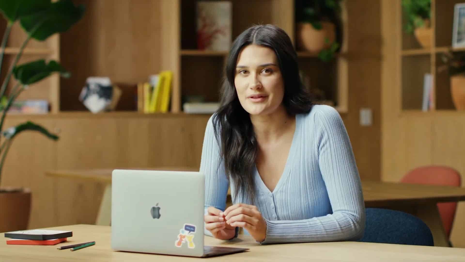 Woman working on a laptop in a cozy office space